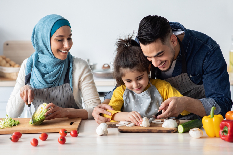 family chopping veggies in the kitchen