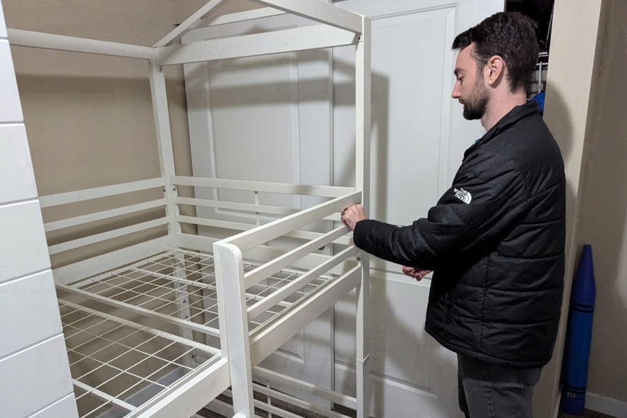 man working on putting a bunk bed together with HelpCity