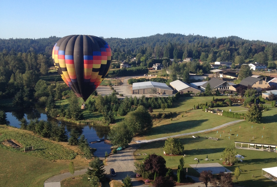 a hot air balloon floating in the air on a sunny day
