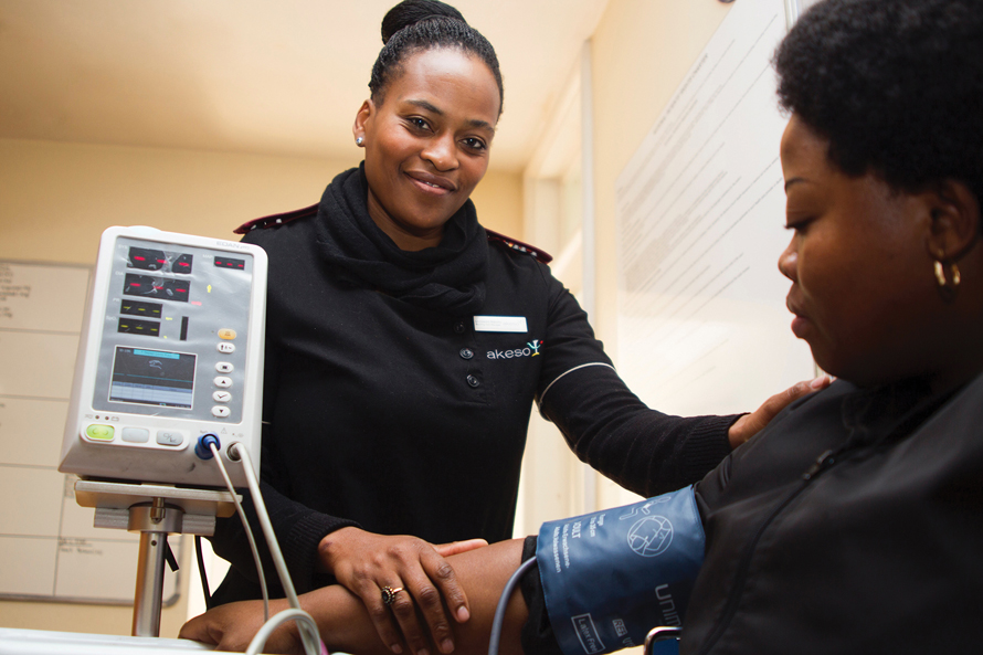 woman taking someones blood pressure