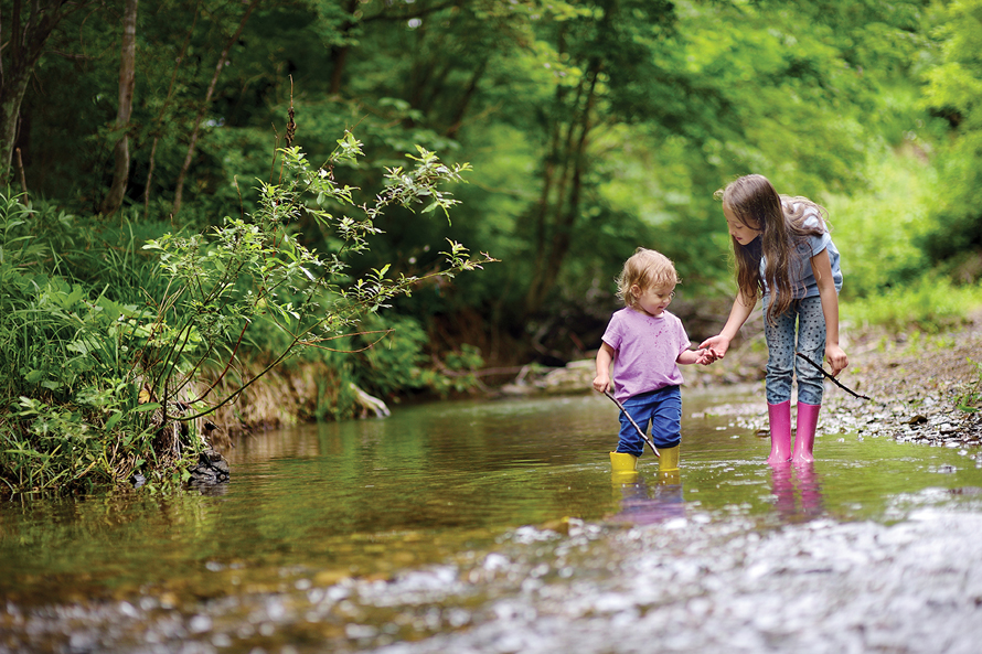 girls exploring a river outside