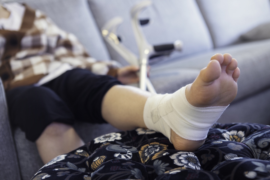 person sitting down with an injured ankle