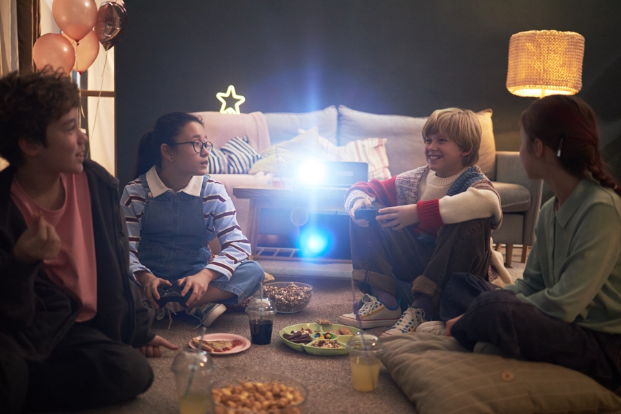 kids siting and eating snacks watching a movie