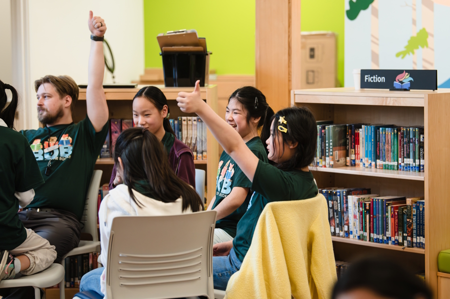 kids giving a thumbs up at Bear Creek school library