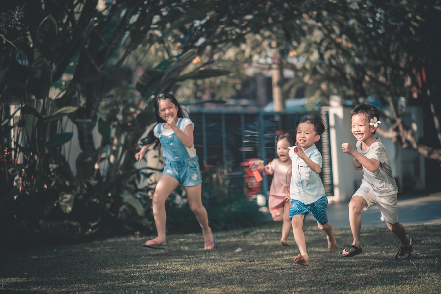 Kids playing a game outside and running
