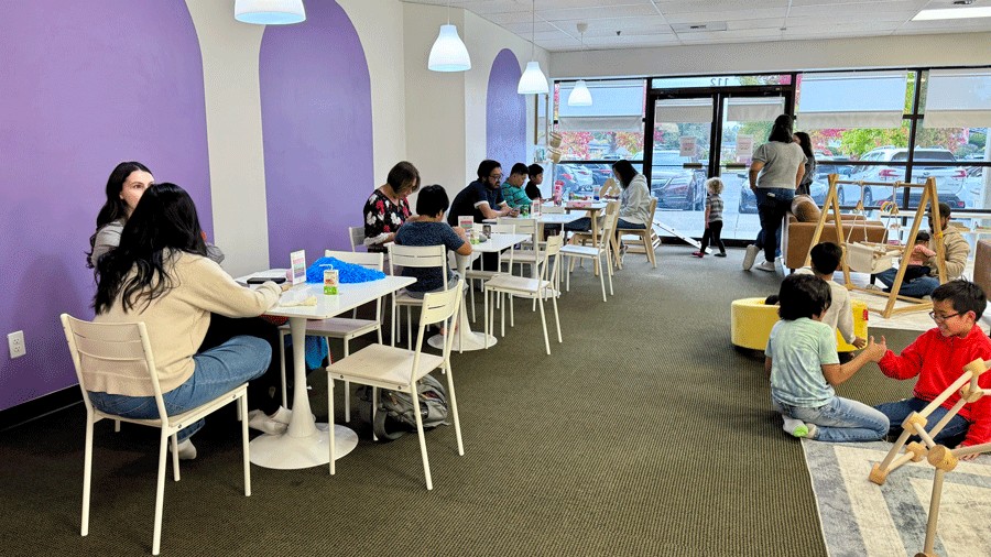 parents and families sitting in the lounge area at Laro Tayo, an indoor venue and play space for families in Kent