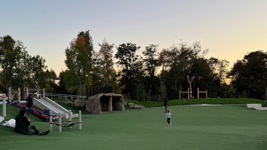 exploring the lighted playground during sunset at Pathways Park in Seattle