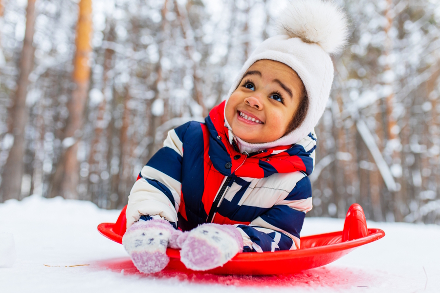 little girl playing outside in the snow 
