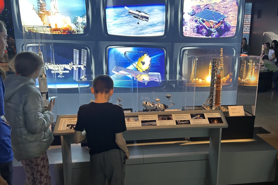 kids looking at lego sculptures