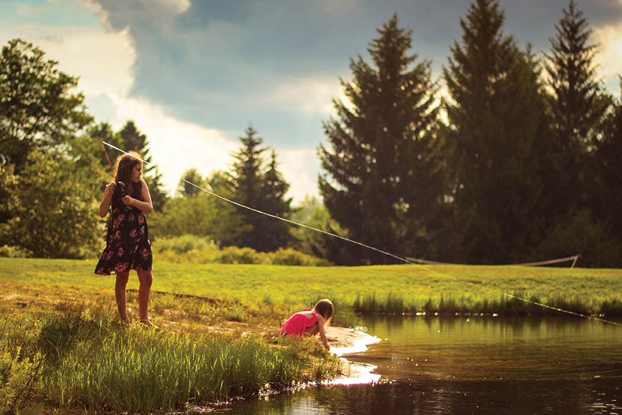 little girl fishing in a lake