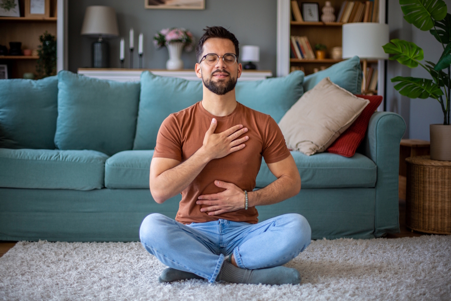 man siting on the floor calmly breathing