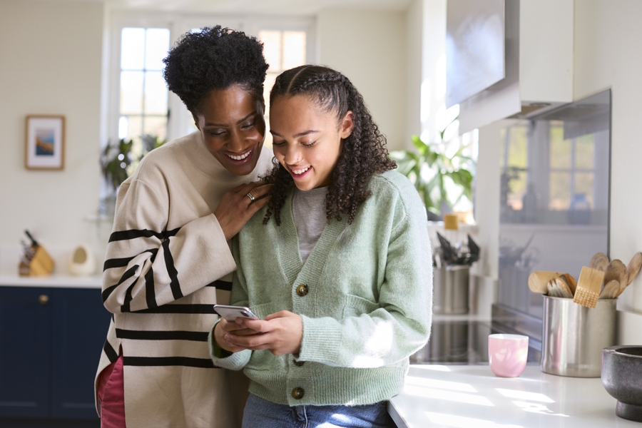 mom and daughter looking at her phone