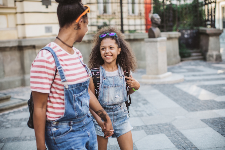 Mom and daughter walking to school together 