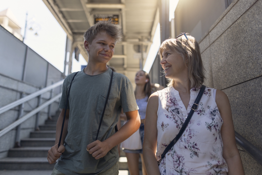 mom and son walking together down stairs
