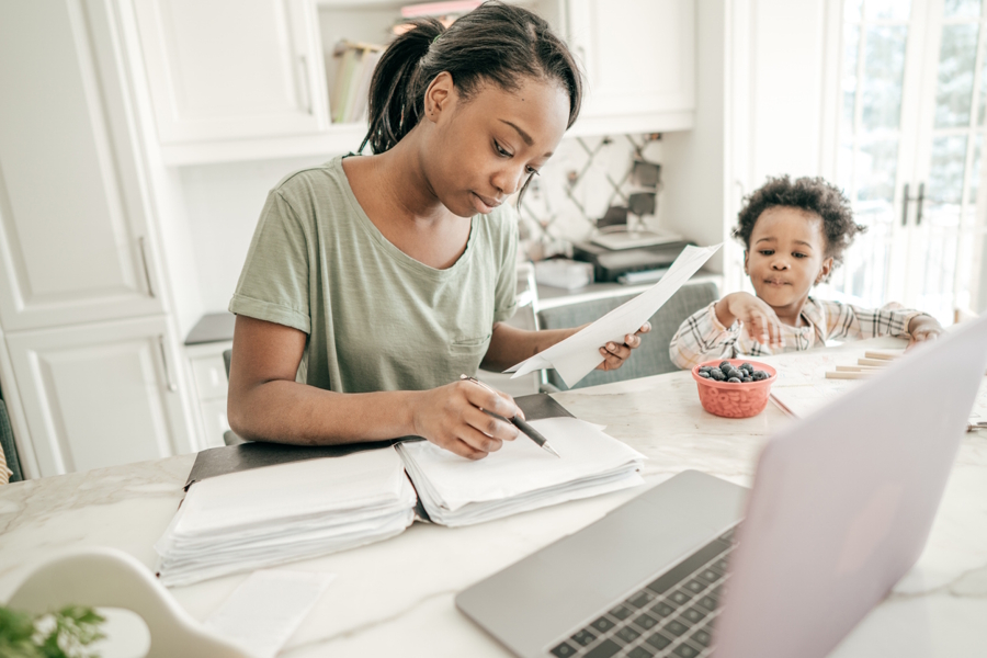 Mom sitting at a table doing a lot of work
