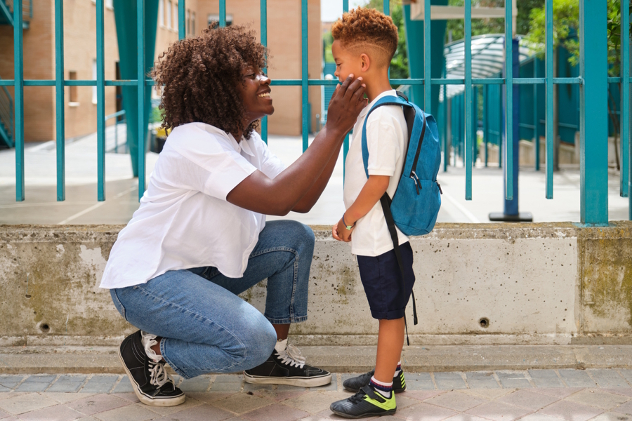 Mom saying goodbye to son on first day of school