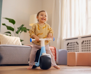 child balancing on woom's new balance bike for babies, gift idea