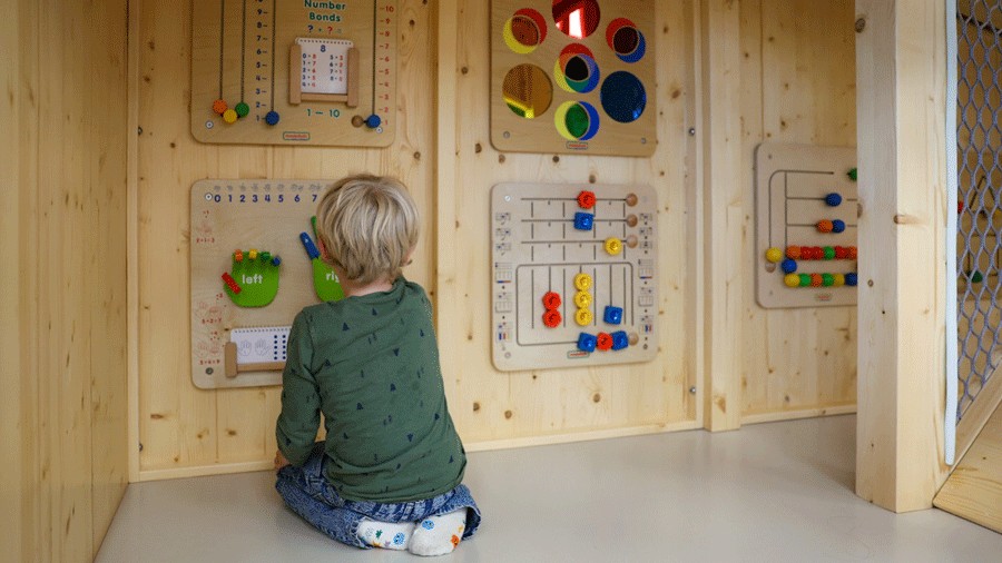 young boy playing with montessori-inspired toys at Nixi City