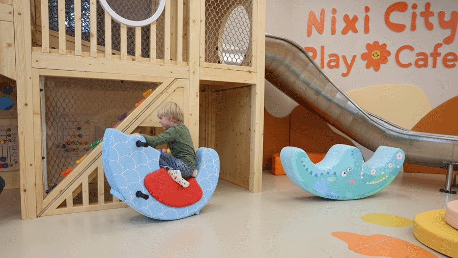 young boy on plush rocker in Nixi City Play Cafe, an indoor play space near Seattle