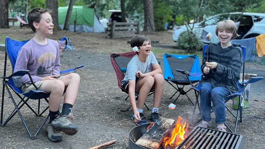 kids roasting marshmallows around a campfire in Oregon