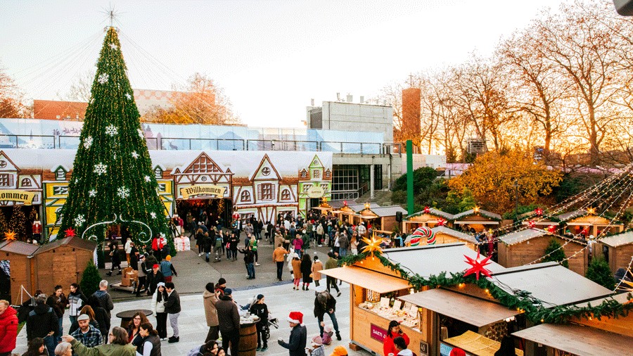 Seattle Christmas Market crowd with the Christmas tree and vendor huts