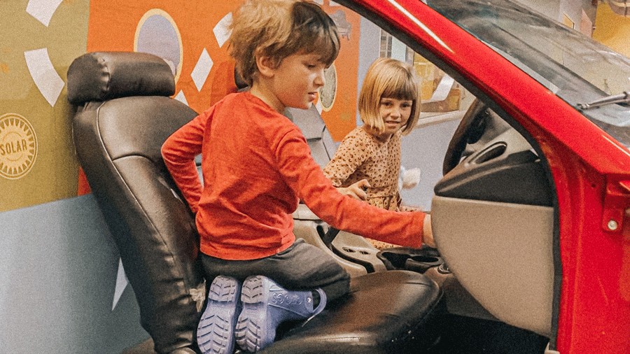 kids playing in a car at LeMay – America’s Car Museum in Tacoma