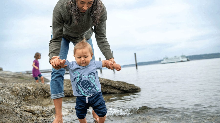 mom and son walking on the beach in port townsend