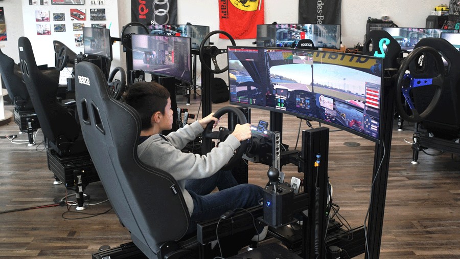 kid playing on racing simulator at GripWerx in Redmond
