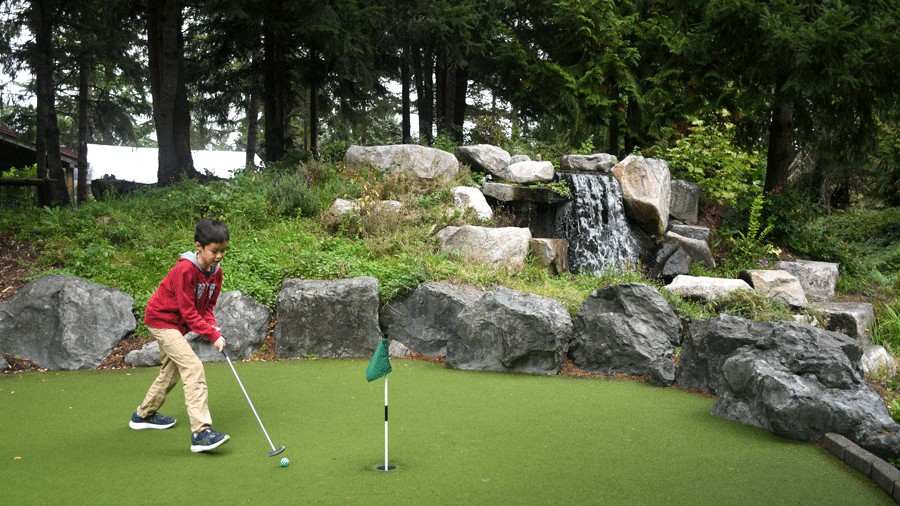 young kid playing mini golf on a Redmond staycation at Willows Run Golf Complex