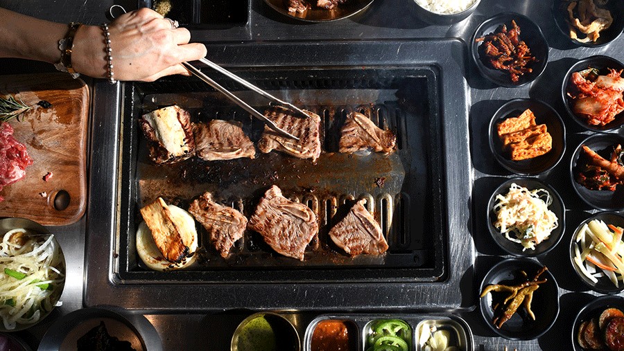 Korean barbecue beef and side dishes on the table at K-Street KBBQ in Redmond