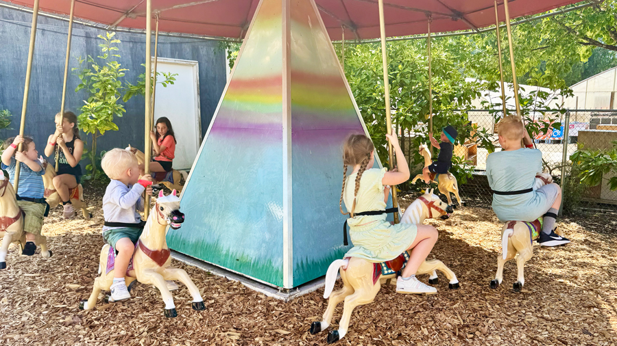 kids on a carousel at remlinger farms during mother's day weekend