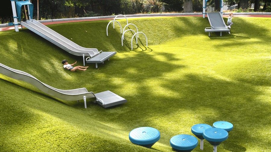 kids rolling down the embankment at Richmond Highlands Park in Shoreline