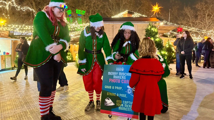 Santa's Elves at the Seattle Christmas Market with a roaming cart of photo props