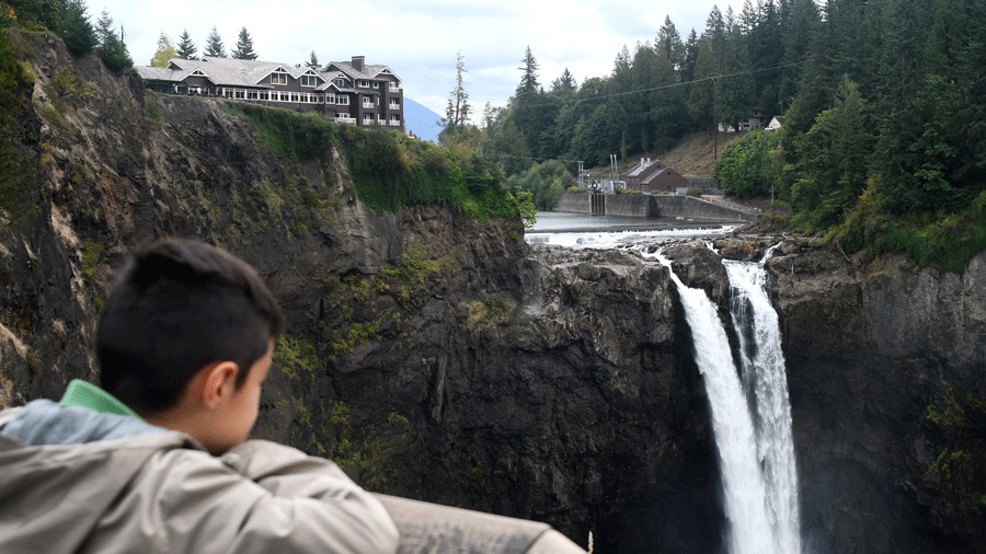 young boy looking at the waterfall and Salish Lodge after a weekend brunch with family