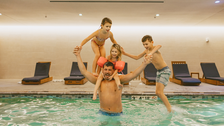 a happy family in the pool at hyatt regency