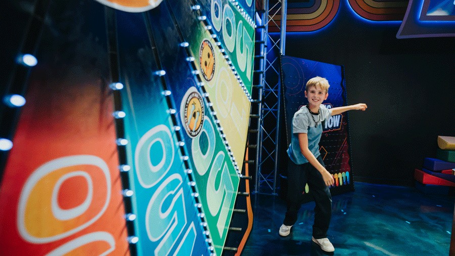 young kid spinning giant wheel at Great Big Game Show Seattle