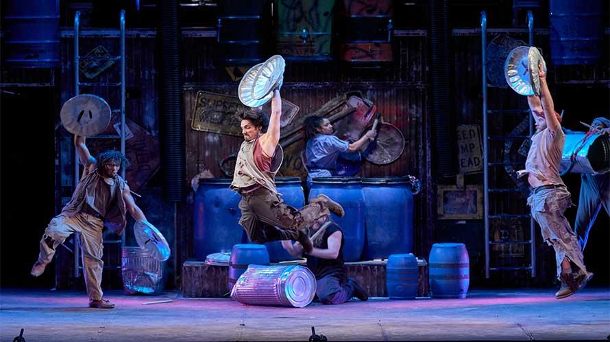 performer soars through the air in "STOMP"