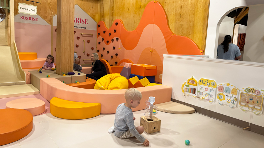 young boy playing on the floor with toys at an indoor playground in Tacoma
