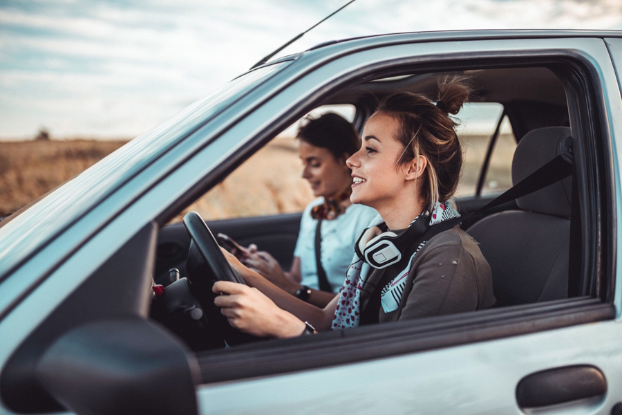 teen girls driving in the summer in a rural area