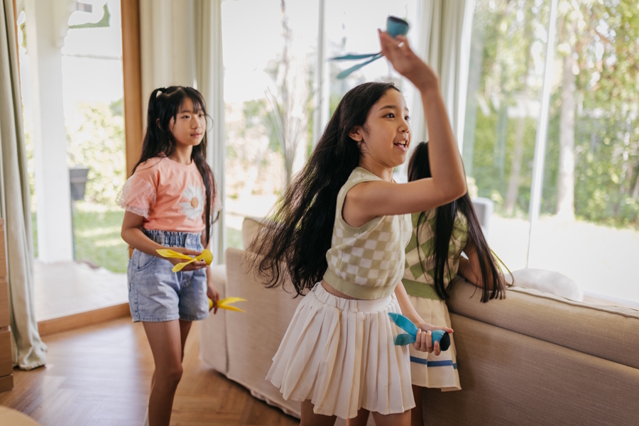 girsl throwing things indoors for an at-home biathlon