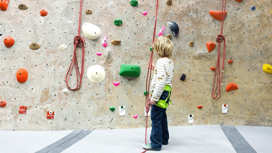 a young kid learns top rope climbing in Seattle 