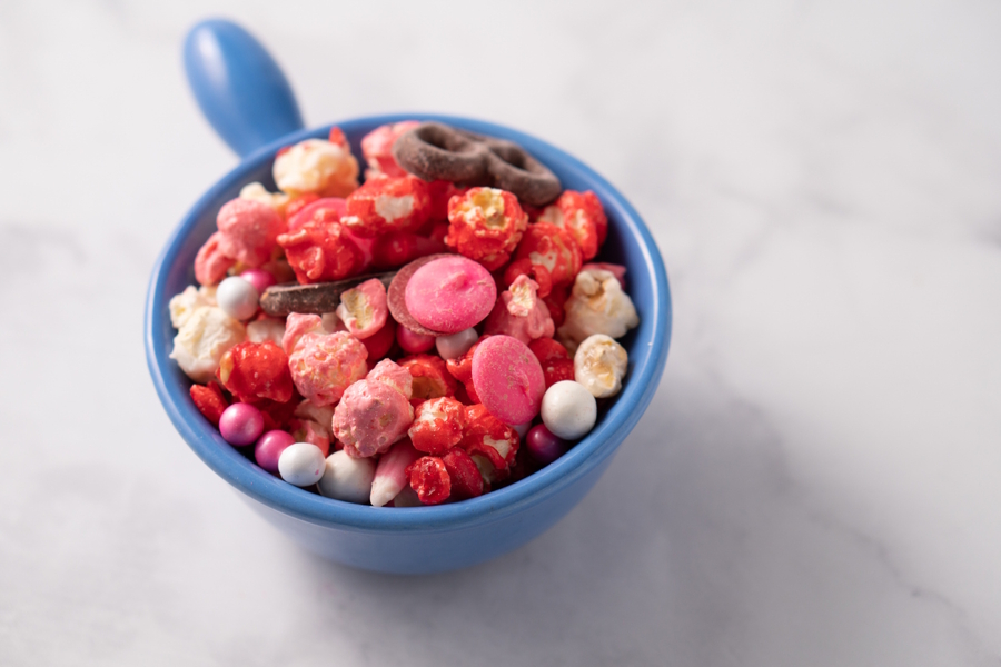 valentine's day snack mix in a blue bowl