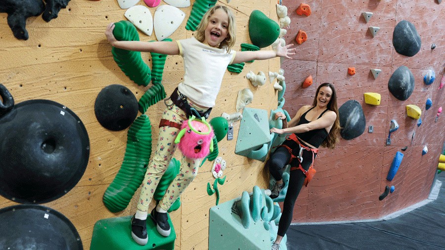 young girl and mom climbing at Vertical World North in Seattle 