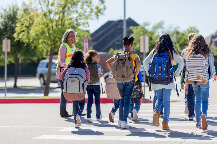 group of kids crossing the street together after school