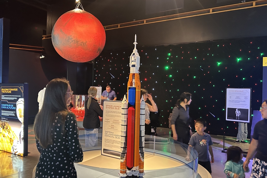adult and child looking at Lego sclpture