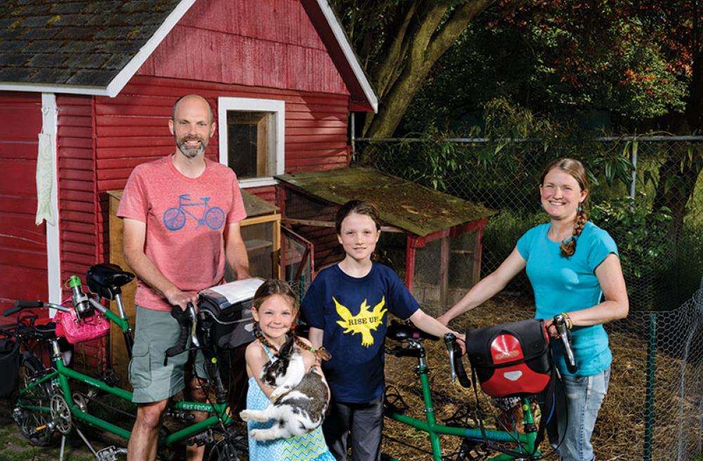 Family with chicken and bike