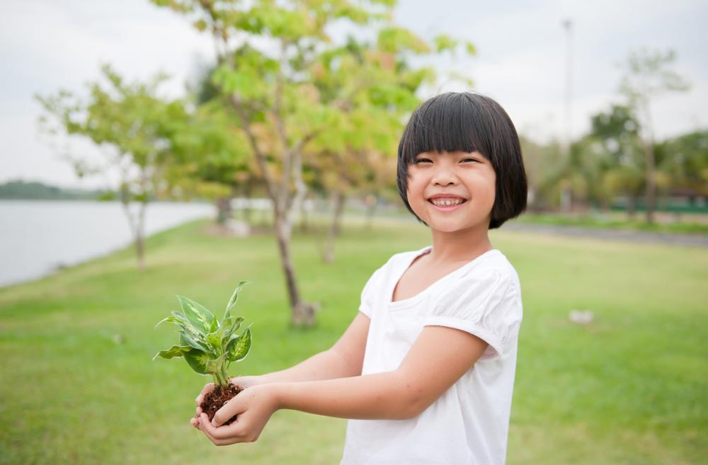 Young Chinese girl holding a plant
