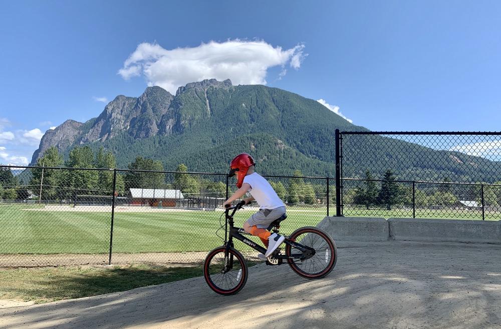 Boy riding a bike at Torguson Park pump track in North Bend, Wash.; pump tracks for Seattle-area kids and families
