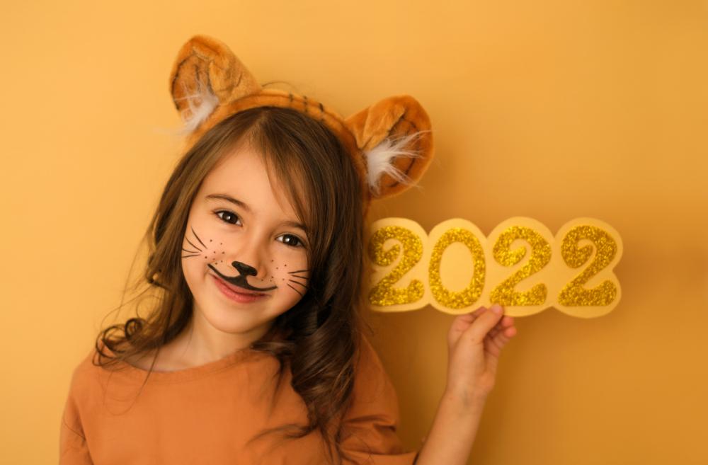 Adorable little girl is dressed as a tiger in celebration of 2022, the Year of the Tiger
