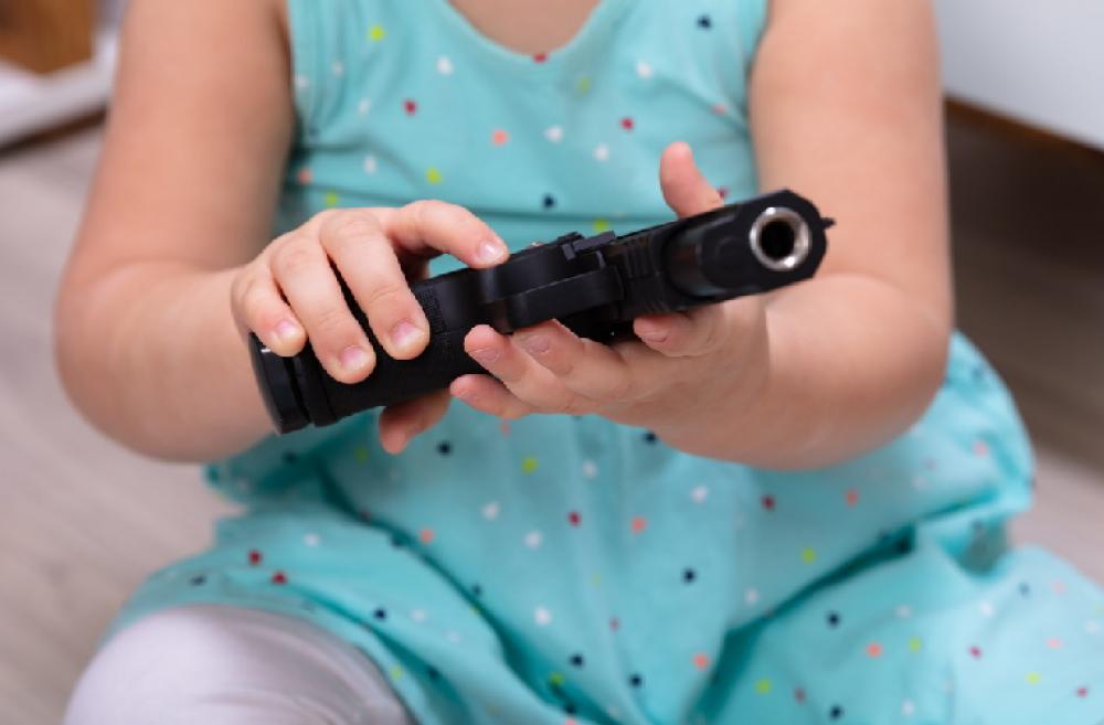 Toddler-holding-a-gun